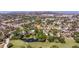 Aerial view showcases the property nestled amidst lush greenery, near a serene golf course and pond at 4340 Narvarez S Way, St Petersburg, FL 33712