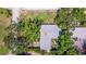 An aerial view of a home with a well-maintained roof surrounded by lush greenery at 4340 Narvarez S Way, St Petersburg, FL 33712