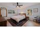 Bedroom with hardwood flooring, ceiling fan, two windows, and a large bed at 4340 Narvarez S Way, St Petersburg, FL 33712