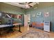 Functional bedroom features work station with multiple monitors and ample natural light at 4340 Narvarez S Way, St Petersburg, FL 33712