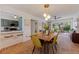 Open dining room with seating for six, terra cotta floors, and modern lighting at 4340 Narvarez S Way, St Petersburg, FL 33712