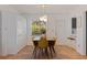 Dining room with modern lighting, seating for four, and white louvered closet doors at 4340 Narvarez S Way, St Petersburg, FL 33712