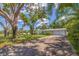 Spacious home featuring a wide driveway, a two-car garage, and a well-manicured lawn with mature trees at 4340 Narvarez S Way, St Petersburg, FL 33712