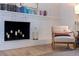 Cozy fireplace with decorative candles and a comfortable chair, creating a relaxing atmosphere at 4340 Narvarez S Way, St Petersburg, FL 33712