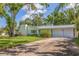 Well-maintained home with green lawn, mature landscaping, a two-car garage, and an inviting entrance at 4340 Narvarez S Way, St Petersburg, FL 33712