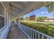 Inviting covered porch with hanging flower baskets and a view of the front yard at 4340 Narvarez S Way, St Petersburg, FL 33712