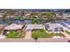 An aerial view showcases the home's well-kept lawn, driveway, landscaping, and waterfront location at 4433 38Th S Way, St Petersburg, FL 33711