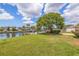 Expansive backyard with a lush lawn, mature shade tree, and dock along the canal, great for outdoor living at 4433 38Th S Way, St Petersburg, FL 33711