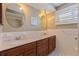 Bathroom featuring dual sinks, round mirrors, and shaker cabinets at 4433 38Th S Way, St Petersburg, FL 33711
