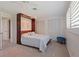 Bedroom features a murphy bed, carpet floors, and natural light from the window at 4433 38Th S Way, St Petersburg, FL 33711