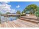Private dock with a boat lift and a picturesque waterfront view, showcasing the serene coastal lifestyle at 4433 38Th S Way, St Petersburg, FL 33711