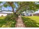 Charming home with a brick walkway, lush landscaping, and a well-maintained lawn, offering great curb appeal at 4433 38Th S Way, St Petersburg, FL 33711