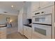 Eat-in kitchen featuring white cabinetry and views into the carpeted living area at 4433 38Th S Way, St Petersburg, FL 33711