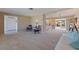 Spacious living room with carpet, neutral tones, and an open layout to other living spaces at 4433 38Th S Way, St Petersburg, FL 33711