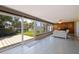 Bright sunroom featuring a fireplace and sliding glass doors to the backyard and canal at 4433 38Th S Way, St Petersburg, FL 33711