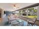 Bright sunroom features a waterfront view through multiple windows and comfortable seating at 4433 38Th S Way, St Petersburg, FL 33711