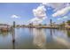 Scenic waterfront view with boats docked, palm trees, and clear blue skies at 4433 38Th S Way, St Petersburg, FL 33711
