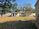 Backyard showcasing the exterior of a single-story home with a grassy lawn at 4716 W Vasconia St, Tampa, FL 33629