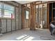 A bathroom area undergoing renovation, featuring tiled floors, exposed framing and a toilet at 4716 W Vasconia St, Tampa, FL 33629