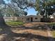 Front exterior view of a home with a wide driveway and mature trees at 4716 W Vasconia St, Tampa, FL 33629