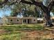 A charming single-story home featuring a spacious front yard and mature trees at 4716 W Vasconia St, Tampa, FL 33629
