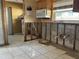 Renovation-ready kitchen showcasing exposed framing, tile floors, and an installed microwave at 4716 W Vasconia St, Tampa, FL 33629