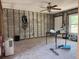Living room with exposed block walls, laminate flooring and a ceiling fan at 4716 W Vasconia St, Tampa, FL 33629