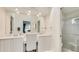 Bathroom view featuring dual sinks, a large mirror, vanity, and a tiled walk-in shower at 4909 Linsey Ct # 0, Sarasota, FL 34243