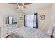 Comfortable bedroom featuring a floral bedspread, wooden ceiling fan, and dresser at 4909 Linsey Ct # 0, Sarasota, FL 34243