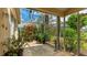 Cozy screened lanai with brick flooring, lush plants, and serene garden decor at 4909 Linsey Ct # 0, Sarasota, FL 34243