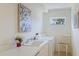 Functional laundry room featuring a washing machine, dryer, sink, and window with flowers at 4909 Linsey Ct # 0, Sarasota, FL 34243
