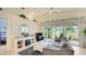 Bright living room boasts vaulted ceilings, stylish decor, and sliding glass doors to a screened lanai at 4909 Linsey Ct # 0, Sarasota, FL 34243