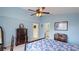 A spacious bedroom includes a full-length mirror, a ceiling fan and access to the bathroom at 4909 Linsey Ct # 0, Sarasota, FL 34243