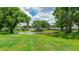Beautiful pond with a fountain surrounded by lush greenery and mature trees at 4909 Linsey Ct # 0, Sarasota, FL 34243
