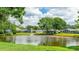 Scenic view of the neighborhood pond with a fountain, surrounded by green lawns and mature trees at 4909 Linsey Ct # 0, Sarasota, FL 34243