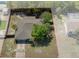 Aerial view highlighting the home's backyard, mature trees, fenced perimeter, and roofline at 5263 Kirkwood Ave, Spring Hill, FL 34608