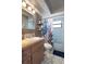 Comfortable bathroom featuring a wooden vanity, decorative shelves, and stylish fixtures at 5263 Kirkwood Ave, Spring Hill, FL 34608