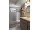 Nicely tiled bathroom featuring modern fixtures, a shower, and wooden shelves for decor at 5263 Kirkwood Ave, Spring Hill, FL 34608
