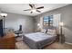Bedroom with a ceiling fan, window, desk, and comfortable bed at 5263 Kirkwood Ave, Spring Hill, FL 34608