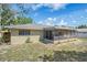 Exterior shot of the rear of the home, featuring a screened porch and well-maintained landscaping at 5263 Kirkwood Ave, Spring Hill, FL 34608