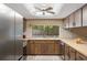 Bright kitchen features wood cabinets, a large window, and plenty of counter space at 5263 Kirkwood Ave, Spring Hill, FL 34608