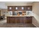 An open kitchen area with dark wood cabinets and bar style counter at 5263 Kirkwood Ave, Spring Hill, FL 34608