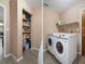 A combination laundry room and pantry with shelving and appliances at 5263 Kirkwood Ave, Spring Hill, FL 34608