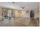 A large living room with wood-look tile flooring, and sliding glass door to patio at 5263 Kirkwood Ave, Spring Hill, FL 34608