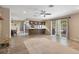 Open concept living room featuring a stone fireplace, kitchen bar and sliding glass doors at 5263 Kirkwood Ave, Spring Hill, FL 34608