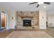 Living room featuring a stone fireplace and wood-look flooring at 5263 Kirkwood Ave, Spring Hill, FL 34608