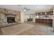 Open living room features a stone fireplace, kitchen bar counter and dining area at 5263 Kirkwood Ave, Spring Hill, FL 34608
