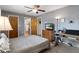 Comfortable bedroom featuring a ceiling fan, a workspace, and a TV atop a wooden dresser at 5263 Kirkwood Ave, Spring Hill, FL 34608