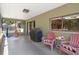 Covered patio featuring casual pink seating and a grill provides a relaxing outdoor living space at 5263 Kirkwood Ave, Spring Hill, FL 34608