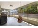 Relaxing screened porch area with a hanging chair overlooking a neatly fenced yard at 5263 Kirkwood Ave, Spring Hill, FL 34608